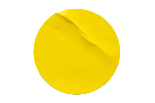 istock Yellow round paper sticker label isolated on white background 1344415371