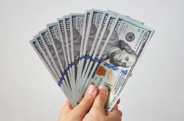 istock Hand with money isolated on white background 1344419003