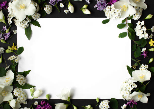 istock Floral frame made of different spring flowers on black background. Flowers flat lay. Space for text 1344419089