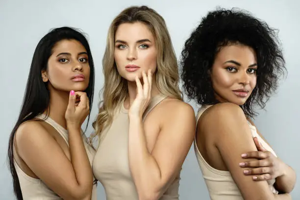 Multi-ethnic beauty and friendship. Group of beautiful different ethnicity women. Black, Caucasian and Indian.