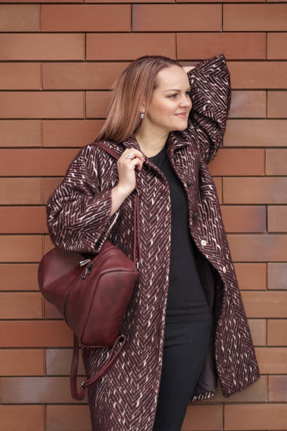 istock Woman posing with a backpack in the city 1344420850