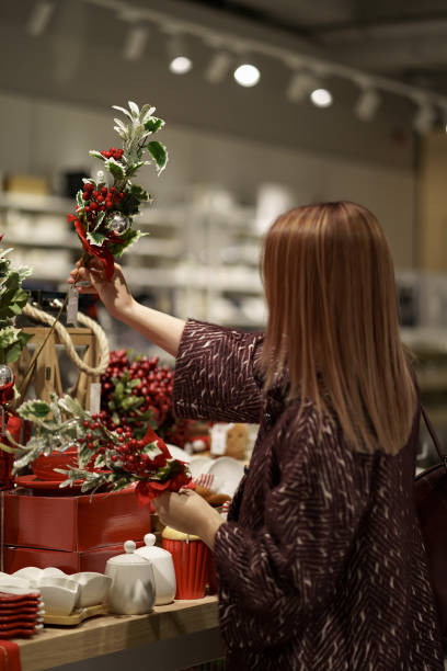 istock Woman chose Christmas decorations in shop 1344420892