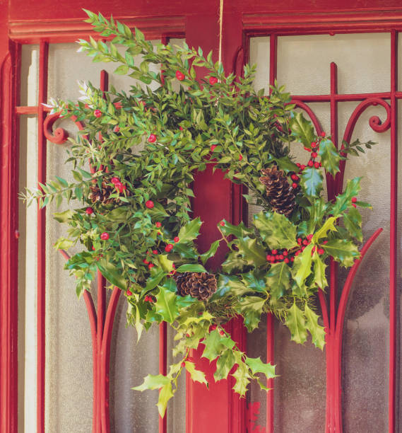 istock Christmas holly wreath on a red door 1344421967