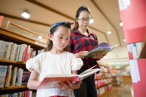 istock Mother and daughter read a book 1344422541