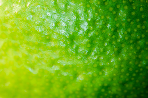 Macro Fruit: Zest of lime, ultra close up, horizontal format, black background