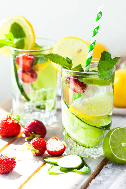 istock Refreshing cold summer drink: cucumber lemonade with strawberry, lemon, lime, mint in a glass. Detox, light beverage with natural organic ingredients for hot weather. Close up macro copy space 1344429842