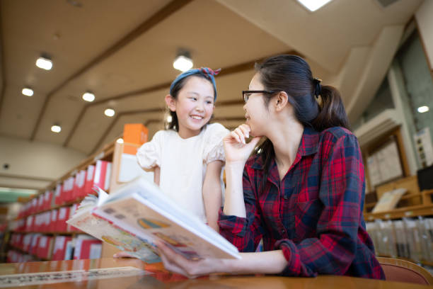 istock Mother and daughter read a book 1344429975