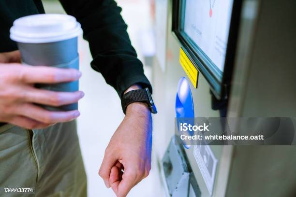 Closeup Of An Asian Man Using Contactless Payment Via A Smart Watch To Pay For A Ticket At A Bts Station Stock Photo - Download Image Now