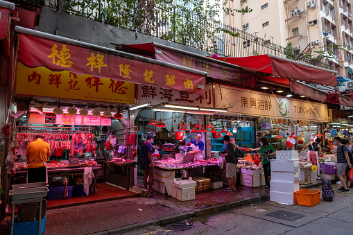 Hong Kong - September 18, 2021 : People at the Wan Chai Market in Hong Kong. The street is full of vendors selling fresh food, vegetable and seafood.