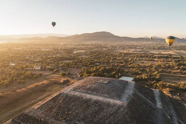 Pyramids of Teotihuacan and hot air balloons in the early light of the morning