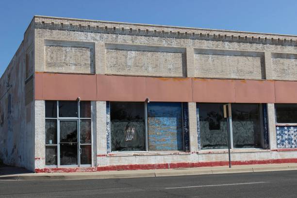 istock Old Abandoned Commercial Building With Blocked Out Window 1344441467