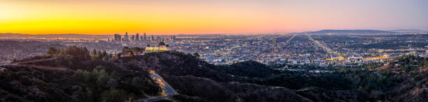 Los Angeles Skyline at Sunrise Panorama and Griffith Park Observatory in the Foreground. California. USA Los Angeles Skyline at Sunrise Panorama and Griffith Park Observatory in the Foreground. California. USA hollywood california photos stock pictures, royalty-free photos & images