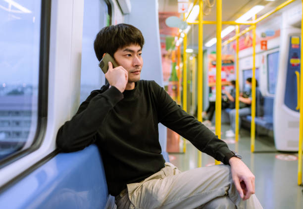istock asian man intern working on smartphone in electric train 1344443799
