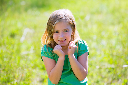 portrait of a smiling little girl in a field