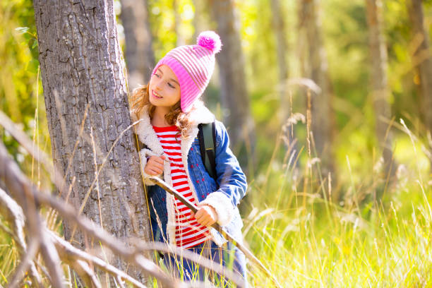 istock Hiking kid girl with backpack in autum poplar forest 1344445466