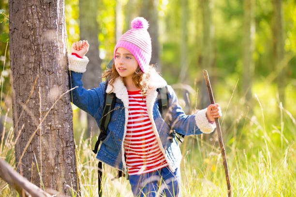 istock Hiking kid girl with backpack in autum poplar forest 1344445478