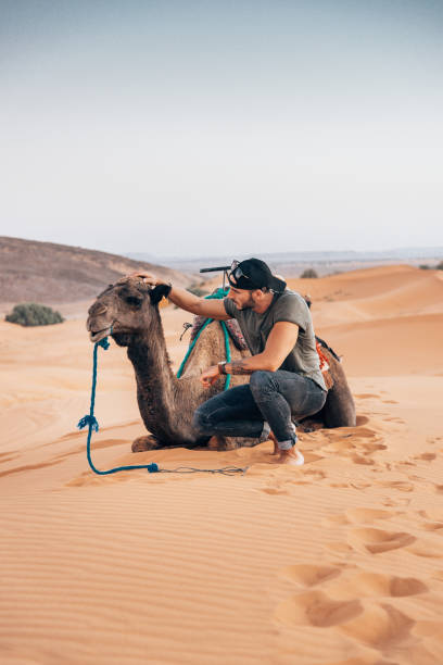 istock man with camel in the desert 1344446191