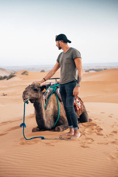istock man with camel in the desert 1344446235