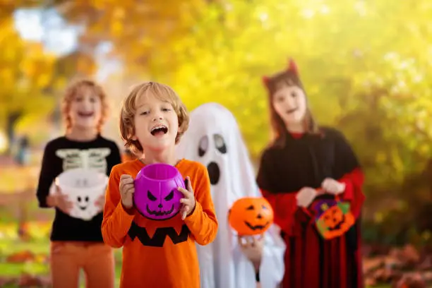 Photo of Kids trick or treat. Halloween fun for children.