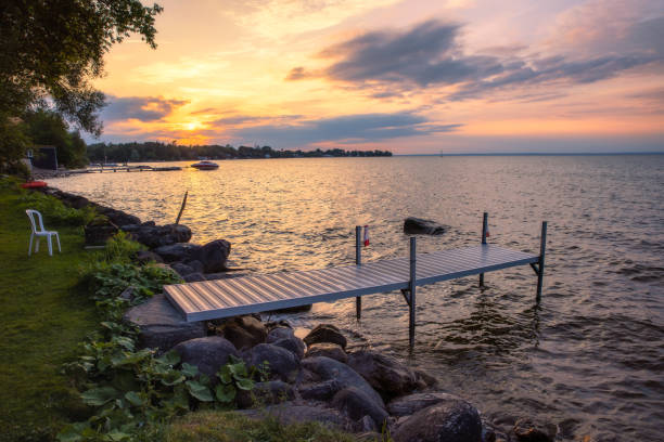 istock Golden moody light on a lakeside dock at sunset. 1344447841