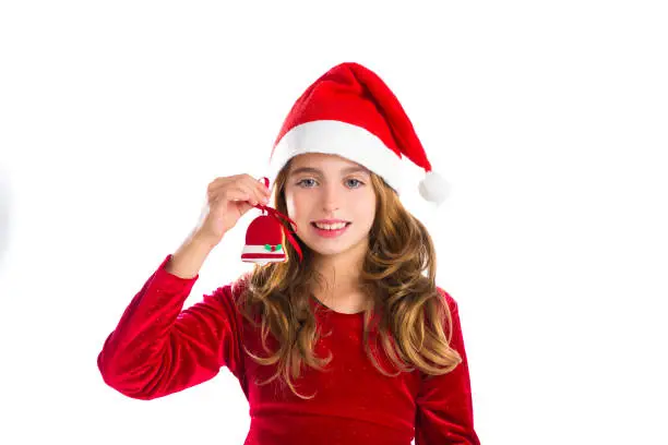 Christmas red bell cookie and Xmas dress kid girl isolated on white background