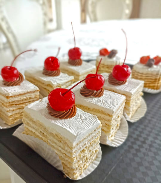 delicious yoghurt cake with butter cream, garnished with red cherries. delicious and beautiful dessert for a holiday, party and relaxation