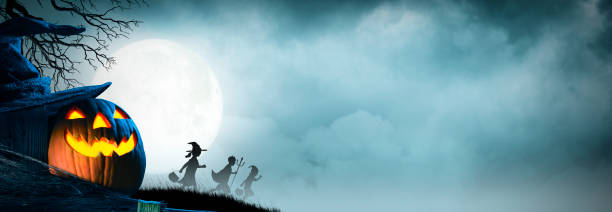 istock Three Children Trick Or Treating Silhouetted Against Moonlit Sky 1344448763