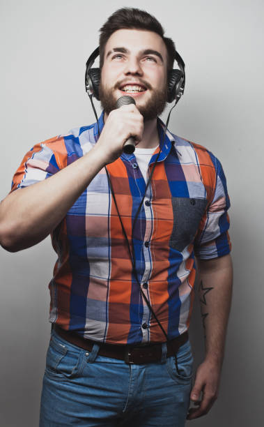 istock Image of a handsome bearded man singing to the microphone 1344448831