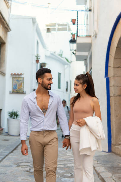 istock Stylish ethnic couple walking in old town 1344449024