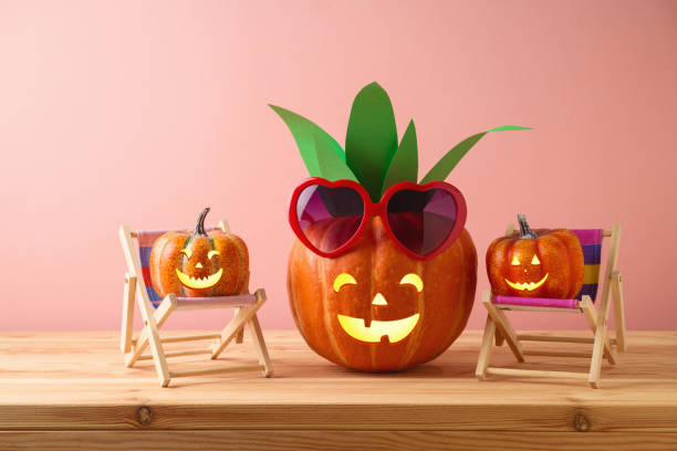 istock Halloween pumpkin creative decor as pineapple with sunglasses on wooden table. Handmade decoration for Halloween party concept 1344449037
