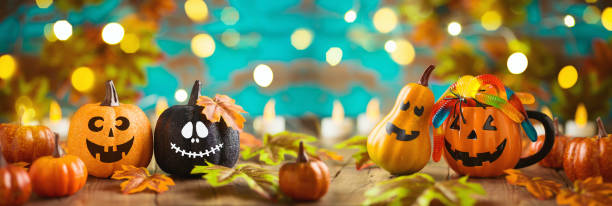 istock Halloween celebration concept with candy corn, jack o lantern cup, pumpkin and autumn leaves. 1344449058