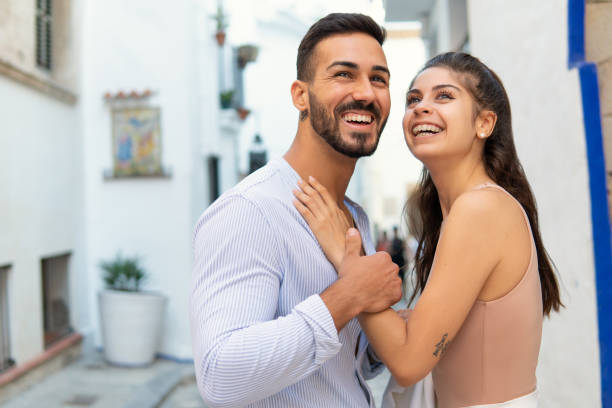 istock Cheerful Hispanic couple embracing in city 1344449814