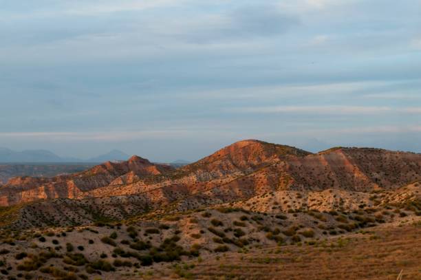 istock Empty desert landscape with open plateau and band of cliffs. 1344452401