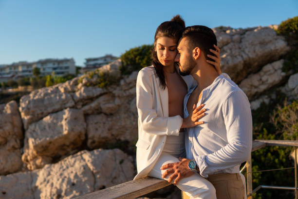 istock Hispanic coupe embracing at viewpoint in mountains 1344453571