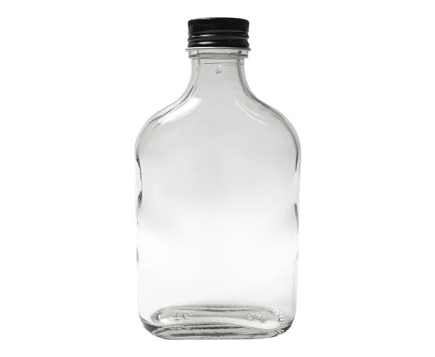 istock transparent bottle glass with black cap isolated on white background with clipping path. flat and wide bottle shape. empty bottle of clear glass flat form for storage beverage. 1344454497