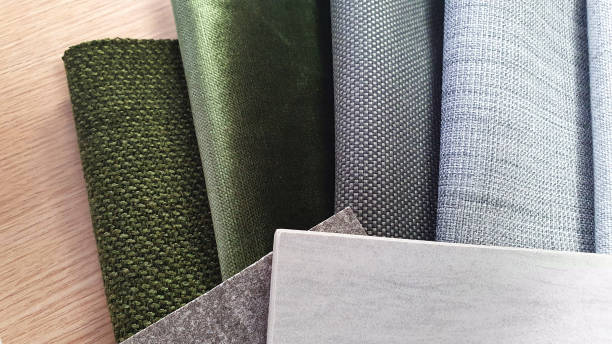 istock close up interior mock up material samples containing fabric drapery in green and grey color tone, grey concrete and travertine stone tiles placed on oak wooden laminated background. mood and tone. 1344454582