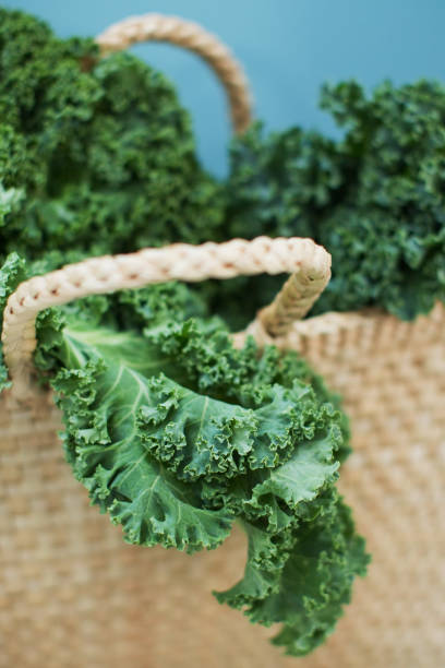istock Green kale salad in straw bag 1344455825