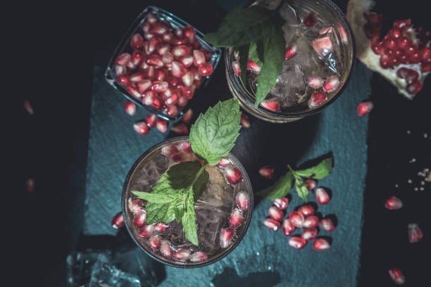 istock two colorful summer cocktails with pomegranate and mint on a black table 1344455868