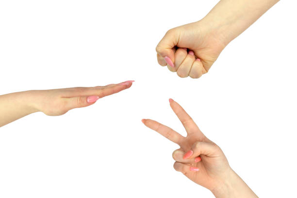 istock Closeup of hands making: Rock, paper, scissors isolated on white 1344456945