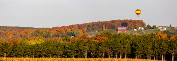 hot air balloon flying over central wisconsin farmland in late september - hayfield imagens e fotografias de stock