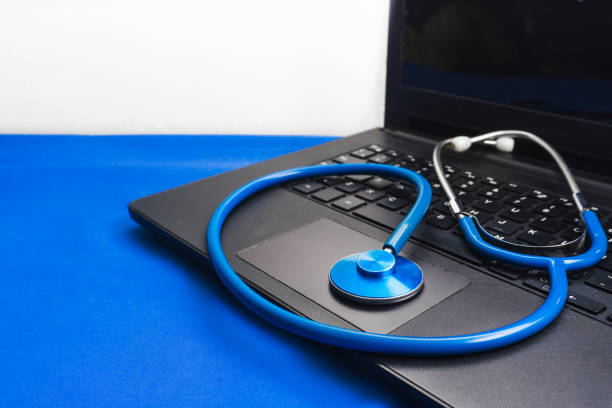 istock closeup of a stethoscope on a black laptop on the blue surface 1344458193