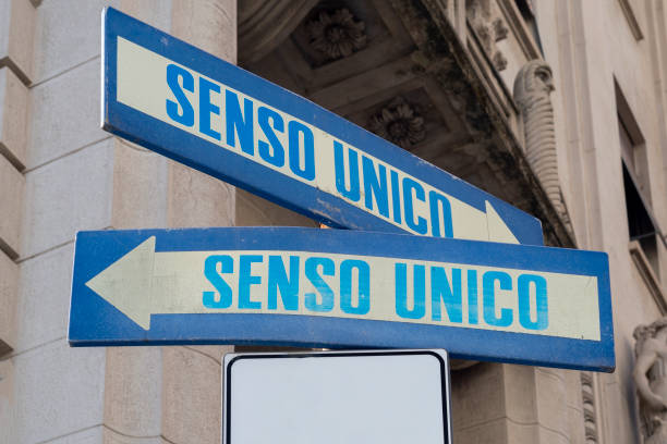 istock Road sign indicating one way (senso unico) in both directions 1344458382