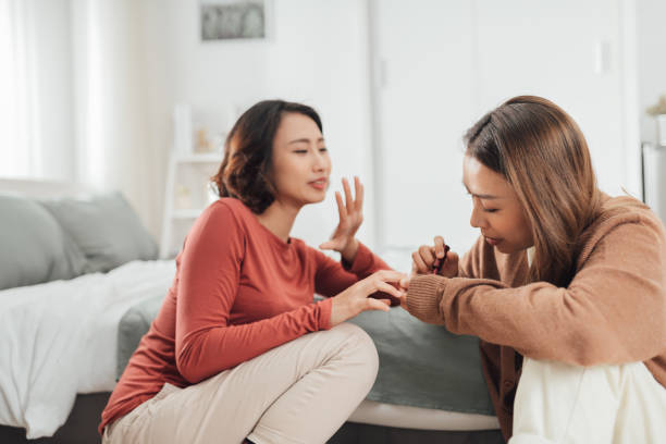 istock Two female friends do a manicure 1344459349