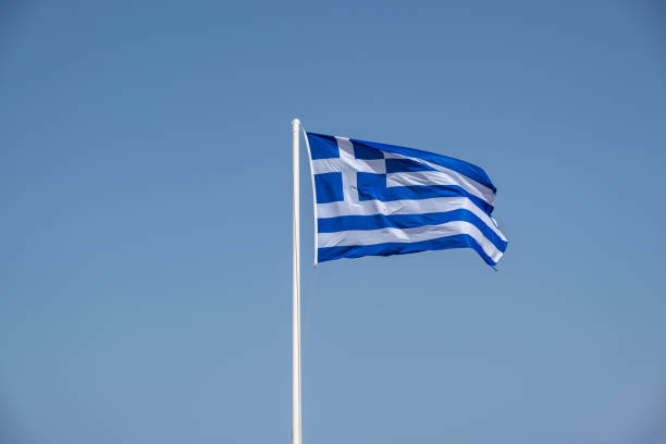 istock Greek flag waving against clear blue sky background. 1344462512