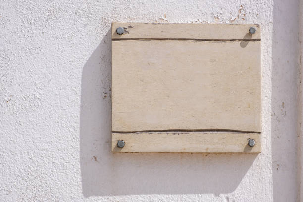 istock Empty blank sign wooden sign. mounted on white wall, copy space, template 1344462516
