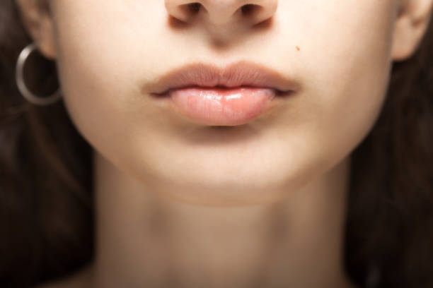 istock Beautiful young girl studio portrait. Abstract lips and nose. 1344463855
