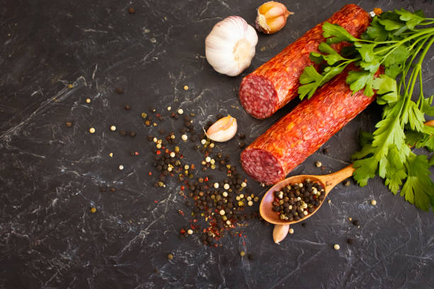 istock sausage salami, spices on concrete background 1344465920