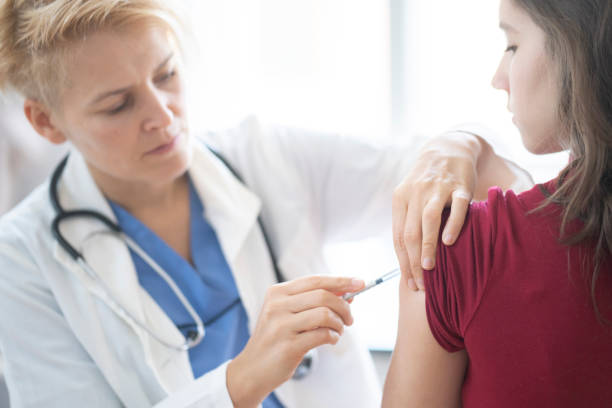 Teenage girl getting vaccinated