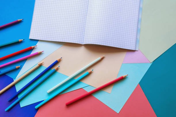 istock Colorful colored paper sheets, colored pencils and open sketchbook 1344468245