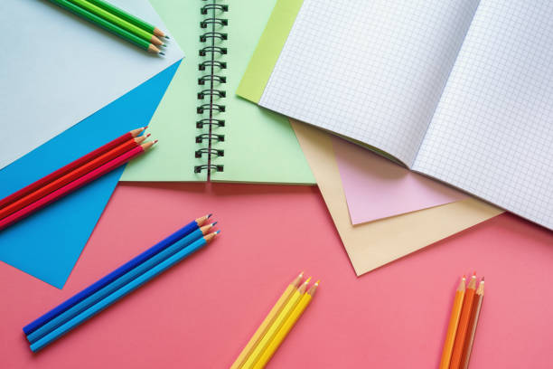 istock Colorful colored paper sheets, colored pencils and open sketchbook 1344468249